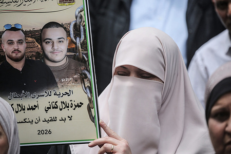 A Palestinian protester holds up a poster of imprisoned Fatah leader Marwan Barghouti during a demonstration against a law passed by the Knesset imposing the death penalty on Palestinians who kill Israeli civilians.