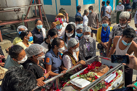 (EDITORS NOTE: Image was created with a smartphone and Image depicts death)
Relatives and family friends pay their last respects, during the funeral of Monywa Aung Shin, National League for Democracy Information secretary, which was held at Yangon's Yay Way Cemetery.
Monywa Aung Shin died from a heart attack.