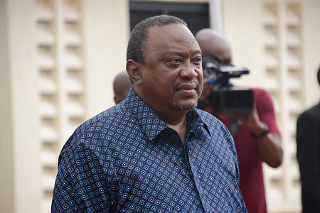 President Uhuru Kenyatta stands still as the national anthem of Kenya is being played at the Directorate of Criminal Investigations (DCI) headquarters in Nairobi, where he presided over the launch of the Directorate of Criminal Investigations (DCI) National Forensic Laboratory.