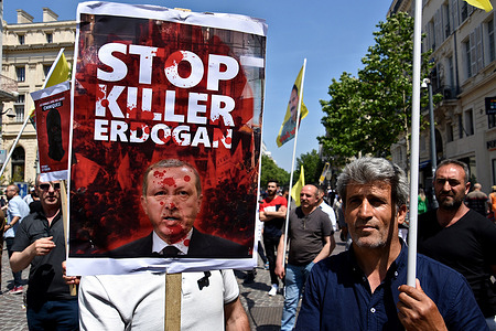 A protester holds a 'Stop Killer Erdogan' placard with a picture of the Turkish president Recep Tayyip Erdoğan during the demonstration. A demonstration is organized by the Kurdish community in Marseille to protest against the Turkish air strikes and demand the release of Abdullah Öcalan, detained for nearly 22 years by the Turkish authorities.