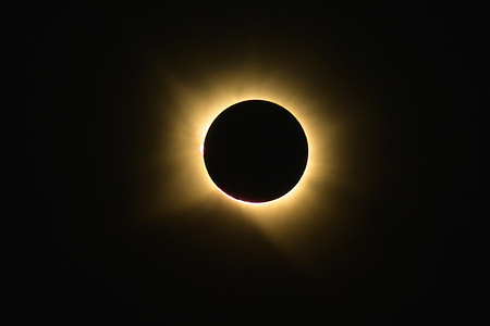 The sun is seen being blocked by the moon during a total solar eclipse observed in Madrid.