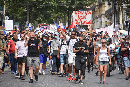 Protesters march on street during the demonstration against the health pass in Marseille.Thousands of people demonstrate against the health pass in Marseille, France. French President Emmanuel Macron announced among new anti-Covid 19 measures a "health pass" which will be necessary to be frequenting café terraces, restaurants, cinemas, theatres and other culture and leisure activities to help contain the spread of the Covid-19 virus.
