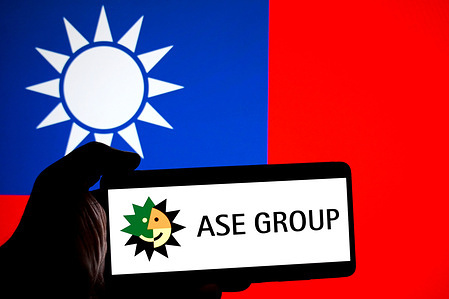 In this photo illustration, an ASE Technology Holding Group logo is seen displayed on a smartphone with a Flag of Taiwan in the background.