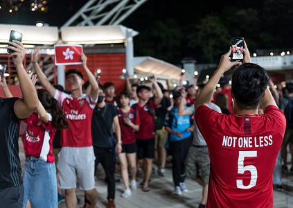A protester wears an anti-extradition themed jersey referring to protesters '5 Demands' as others form a human chain during the halftime intermission.
Hong Kong fans cheered for their team while also chanting various anti-extradition slogans. Protesters formed a human chain during the halftime intermission in hopes of drawing further attention to the unrest in Hong Kong.
(Final score: Iran 2:0 Hong Kong)