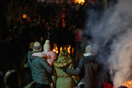 A family awaits the horse parade during the annual "Luminarias" celebration on the eve of Saint Anthony's day. The inhabitants of San Bartolome de Pinares celebrate the luminaries festival every January 16 in honor of the patron saint of animals, Saint Anthony the Abbot. This is a tradition that dates back 500 years with the aim of purifying the animals with the smoke of the bonfires and protecting them for the coming year.