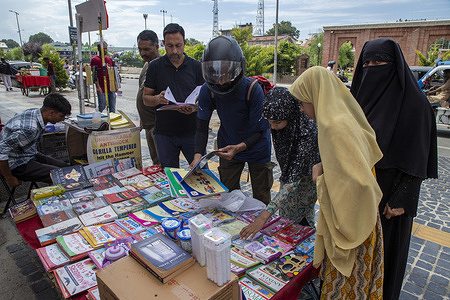 Kashmiri people browse books displayed on a handcart in capital city Srinagar. Authorities in Indian-administered Kashmir on August 6, 2025, ordered a ban on 25 books, including works by prominent Indian and international authors, alleging that the titles promote what authorities called “false narratives,” “glorify terrorism,” and “incite secessionism.” The banned books cover a wide range of subjects, including human rights, politics, gender, history, and military occupation. Authorities said the decision was based on intelligence reports and investigations that found the content had influenced youth toward “violence,” “a culture of grievance,” and “terrorist heroism.”