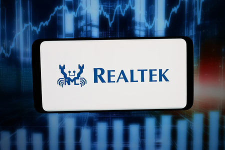 In this photo illustration, the logo of Taiwanese company Realtek Semiconductor Corp. is displayed on a smartphone in front of abstract background on computer screen.
