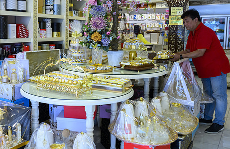 A shop worker arranges trays of chocolates on display at a confectionery shop ahead of Eid al-Fitr, marking the end of the Muslim holy fasting month of Ramadan.