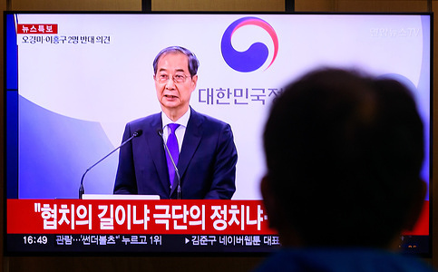 A Man looks at a 24-hour Yonhap news TV broadcast at Seoul Railway Station showing a news broadcast with shows acting South Korean President and Prime Minister Han Duck-soo delivers an address to the public at the government complex in Seoul. Acting South Korean President Han resigned on May 1, indicating he would run for the June 3 presidential election.