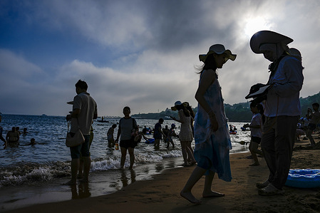 Tourists are sunbathing on the beach at the Golden Sand Beach in summer