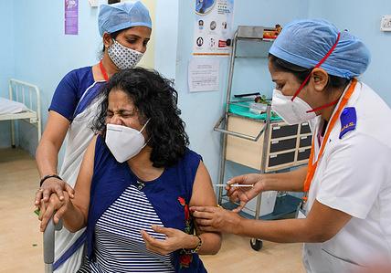 A nurse seen vaccinating a female frontline medical worker in Rajawadi hospital.
The nationwide Covid-19 vaccination program began today in India. Frontline health workers are the first group of people to be vaccinated.