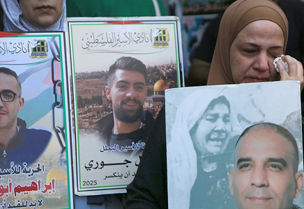 A Palestinian mother weeps as she holds up a portrait of her son, who is being held in Israeli jail during a sit-in protest. Demonstrators held up portraits of their imprisoned sons during a sit-in protest at the entrance to the commercial market in downtown Nablus in the West Bank, demanding their release. They explained that their sons are living in deplorable conditions, suffering from severe shortage of food and medicine, and that they have not been able to visit them since October 7, 2023.