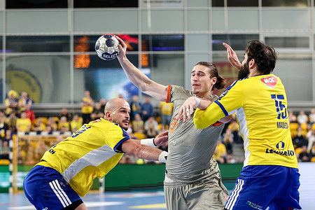 Artsem Karalek of Industria Kielce (L), Juri Knorr of DEN Aalborg Handbold (C) and Jorge Maqueda Peno of Industria Kielce (R) seen in action during the EHF Champions League 2025/2026 match between Industria Kielce and DEN Aalborg Handbold at Hall Legionow. Final score Industria Kielce 32 : 32 DEN Aalborg Handbold.