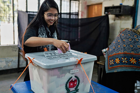 A voter casts her ballot during the 13th general election. The election will determine the country's next government as millions of voters head to the polls amid heightened political tension and security concerns.