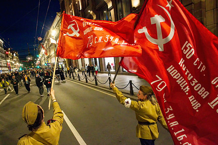 Women in 1945 military uniforms walk down Nevsky Prospekt with Soviet Union flags during a city-wide Victory Day celebration. Russia celebrated the 78th anniversary of the complete and final victory in the Great Patriotic War over Nazi Germany. Victory Day was celebrated in many cities of the country on May 9. The main celebration was held in Saint Petersburg and Moscow. Thousands of people in Saint Petersburg took to the streets of the city to honor the victims of World War II.