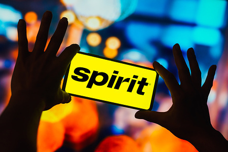 In this photo illustration, the Spirit Airlines logo is displayed on a smartphone screen.