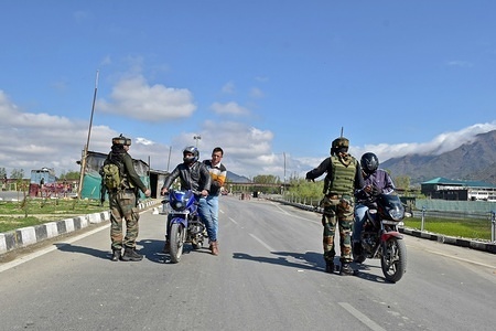 Indian army soldiers seen stopping motorcyclists on a main National Highway on the outskirts of Srinagar, Kashmir.
The government has prohibited the movement of civilian traffic on the main National Highway to keep it open for military convoys for two days every week. The order comes weeks after 40 paramilitary troopers were killed in a suicide attack on February 14