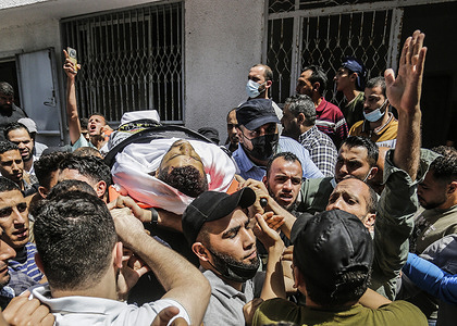 (EDITORS' NOTE : Image depicts death)
Palestinians carry the body of an Islamic Jihad fighter during his funeral in Al Shejaeiya neighborhood, east of Gaza.
Three Islamic Jihad were killed after Israeli air strike in Gaza on 11th May. Israel Defense Forces (IDF) said they hit over 100 Hamas targets in the Gaza Strip during a retaliatory overnight strike after rockets were fired at Israel by Palestinian militants.