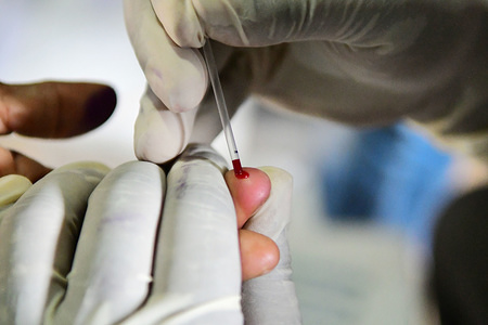 A health worker is seen drawing blood from a tribal woman.
A health worker is collecting blood samples from tribal women and preserving them as the samples will go for HIV testing in a free health campaign organized by a private concern in the outskirts of Agartala, capital of the northeastern state of Tripura.