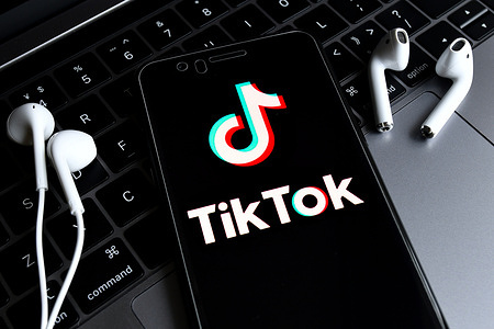 In this photo illustration, a TikTok logo seen displayed on a smartphone with a computer in the background.
ByteDance, parent company of popular video-sharing app TikTok on Sunday confirmed it would be filing a lawsuit on Monday local time against the Trump administration over the executive order signed by President Donald Trump banning its service in the United States.