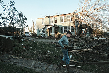 A resident of Mayfield in Kentucky removes personal belongings from home, destroyed by the tornado that touched down. There is at least 74 dead in Kentucky after four tornados touched down in the state during the severe weather outbreak last week.