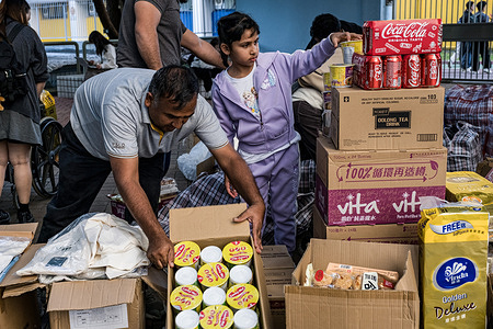 The South Asian community has set up a distribution point for emergency supplies. On Wednesday 26th November, a tower in Wang Fuk Court, which is an eight-tower complex in Tai Po, Hong Kong caught fire, while the complex had been under renovation, the towers were clad in bamboo scaffolding and mesh, it led to the rapid spread of the deadly fire to the other six towers. The incident soon escalated to Level 5 fire, for the first time in 17 years. After an overnight rescue operation by firefighters and police force, the fire was reportedly under control. The death toll still rising following the continuation of the rescue work. Many local residents have also volunteered to allocate and deliver emergency supplies to displaced residents of the complex.