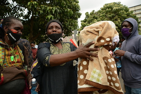 Women wearing facemasks with names of loved ones killed are seen during the demonstrations.
Residents of Mathare slums demonstrate outside the parliament building in a protest against police killings and brutality in the area while wearing facemasks with names of those who had been killed by police.