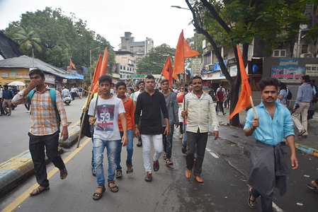 Protesters seen demonstrating with flags.
Members of the Maratha Kranti Morcha group went on strike to demand quotas for Marathas in government jobs and education across Maharashtra state.