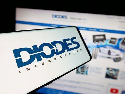 In this photo illustration, a smartphone with the logo of US semiconductor company Diodes Incorporated is seen on screen in front of website.