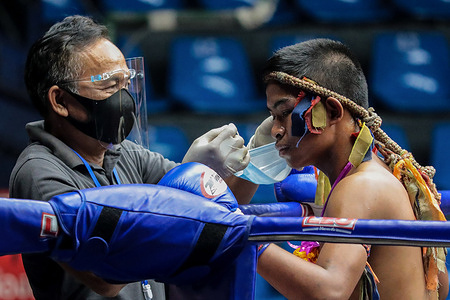 Don Sak Sak Winai seen wearing a face mask before the Thai Boxing match that was held without spectators as a preventive measure against the spread of COVID-19 coronavirus at Rajadamnern Stadium.