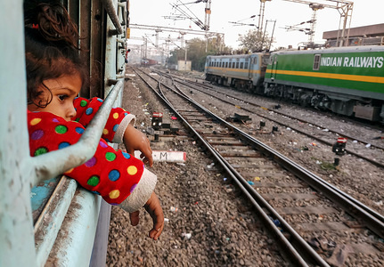 A young Indian girl seen looking out from a train in Punjab, India.
Punjab, a state bordering Pakistan, is the heart of India’s Sikh community. The state is bordered by the Indian states of Jammu and Kashmir to the north, Himachal Pradesh to the east, Haryana to the south and southeast, Rajasthan to the southwest, and the Pakistani province of Punjab to the west. Punjab is primarily agriculture-based due to the presence of abundant water sources and fertile soils. The population of Punjab is estimated to be 30,452,879 (30.4 million) in 2018.