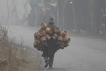 A Kashmiri man seen carrying fire pots on a cold and foggy winter morning in Srinagar. Fresh snowfall in Gulmarg on Sunday signaled the onset of Chillai-Kalan, the harshest 40-day winter period in Kashmir beginning December 21. The severe winter phase, locally known as Chillai-Kalan, brings subzero temperatures across the Himalayan region. During this period, temperatures can plunge to as low as minus 20 degrees Celsius (minus 4 degrees Fahrenheit), triggering intense cold waves. Water bodies, including the world-famous Dal Lake, often freeze, while water supply lines in several parts of the valley face disruption.
