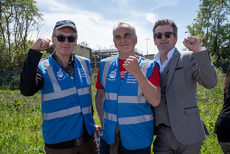 The founders of the Windrush Against Sewage Pollution (WASP), Ash Smith (C) and Peter Hammond (L) and the former frontman of the Undertones, Feargal Sharkey (R) pose for a photo during the demonstration by the Southern Water site on the Tankerton Beach. Supporters of the SOS Whitstable gathered on the Tankerton Beach in Whitstable, UK. Protesters marched on the beach led by the former front man of the Undertones, Feargal Sharkey to the Southern Water site. Campaigners demand from the water companies to responsibility for their ignorance and mistakes to polluting the rivers and seas.