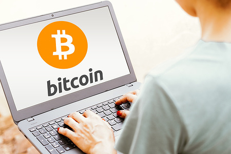 In this photo illustration, the Bitcoin logo is seen displayed on a laptop screen.
