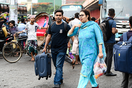 People prepare to board buses to take them back to their native home to celebrate the Eid-Al Adha festival with their families and friends at the Mohakhali bus terminal. Muslims across the world celebrate the annual festival of Eid al-Adha, or the Festival of Sacrifice, which marks the end of the Hajj pilgrimage to Mecca and in commemoration of Prophet Abraham's readiness to sacrifice his son to show obedience to God.