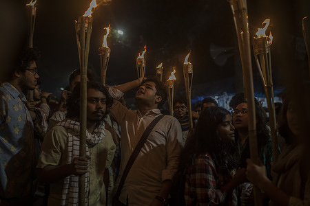 Protesters holding torches chant slogans during the demonstration. A programme titled “Ganer Artonad” (songs of outcry) was organized at Shahbagh by Sampriti Jatra, a platform of writers, artists, rights activists and left-leaning political workers, demanding the unconditional release of Baul singer Abul Sarkar and justice for the attack on Baul artists in Manikganj.