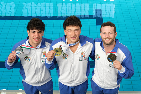 Gold medallist Matteo Santoro (C), silver medallist Valerio Mosca (L) and bronze medallist Lorenzo Marsaglia (R) on the podium after the Italian Absolute Indoor Open Diving Championships – Men’s 1m Springboard Final at the Piscina Monumentale.