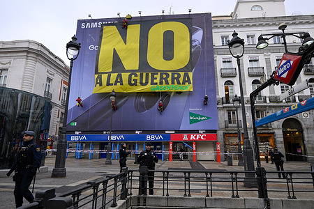 Greenpeace banners are seen hanging from a building facade in Madrid's Puerta del Sol. Greenpeace activists unfurled a large banner in Madrid's Puerta del Sol to protest the conflict in Iran, bearing the slogan 'No to war'.