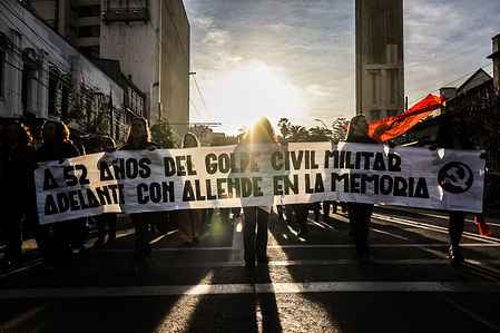People carry a banner as they march during the commemoration of the 52nd anniversary of the 1973 coup d'état. Hundreds of demonstrators marched through the main streets of Valparaíso to mark the 52nd anniversary of the 1973 coup d'état that overthrew Salvador Allende's government. The demonstration honored the memory of those detained, disappeared, and executed during Augusto Pinochet's dictatorship.