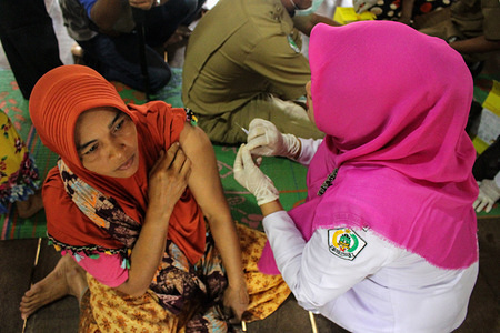 Medical officers are conducting vaccine injections to a woman to prevent and spread Diphtheria outbreaks in remote villages of Aceh Utara District. According to the Health Service of the Republic of Indonesia, currently people are facing a Diphtheria outbreak, of 591 diphtheria cases 32 of whom die throughout 2017. Most of the diphtheria outbreak affects children aged 5 to 15 years, caused by bacterial infections.