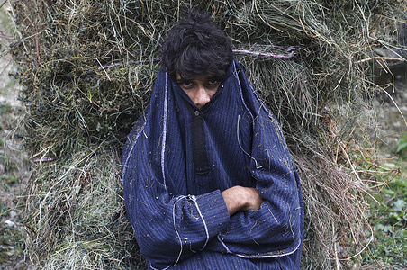 A man carries a grass sack along a mountain path in Pahalgam, Indian-administered Kashmir. The scenic valley, known for its pastoral beauty and pilgrimage routes, has also witnessed periods of tension between India and Pakistan.