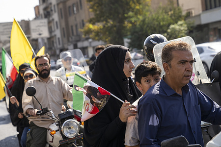 A family rides a motorcycle during the 40,000-strong “Sacrifice for Iran” motorcycle rally. Tens of thousands of motorcyclists paraded across central Tehran as part of the state-backed "Sacrifice for Iran" (Jan-Fada) rally. Organized by the Islamic Revolutionary Guard Corps and Basij militia, the procession traveled from Imam Hossein Square to Azadi Square to mark Sacred Defense Week and demonstrate public support for national defense initiatives.