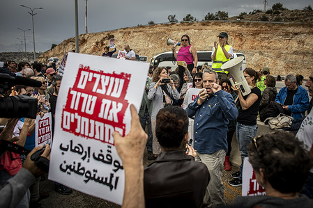 Israeli Democratic Member of Parliament Gilad Kariv speaks during a demonstration at the Oranit checkpoint in the Israeli-occupied West Bank. The Israeli army declared a West Bank village a closed military zone on Friday, shortly before hundreds of Israeli activists were scheduled to join an olive harvest there. Police intercepted their buses at a checkpoint, preventing them from reaching the village of Burin.