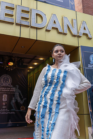 A model seen wearing a dress inspired by the colors and design of the Argentina national Football Team during the street Fashion show ahead of the FIFA World cup.