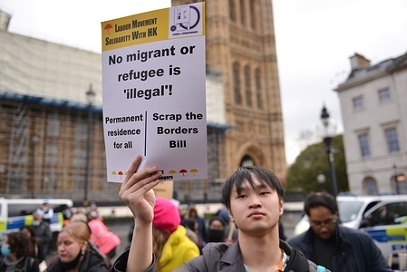 Demonstrator holds a placard that says No Migrant Or Refugee Is Illegal during the rally. 
Protesters gathered in Old Palace Yard, Westminster, to express their opposition to the Nationality & Borders Bill.
