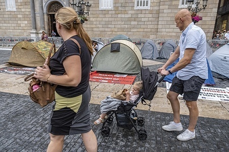 Tourists are seen passing in front of the tent camp set up during a strike in Plaza de Sant Jaume.
Second day of hunger strike in Plaza Sant Jaume by businessmen and nightlife workers after the TSJC (Supreme Court of Justice of Catalonia) validated the arguments of the Generalitat de Catalunya to keep nightlife closed due to the so-called fifth wave of Covid19.