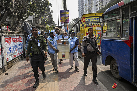 Ballot boxes and other election material for the 13th national parliamentary election are distributed under the supervision of law enforcement officers for deliveries to various polling centers across the capital in Dhaka.