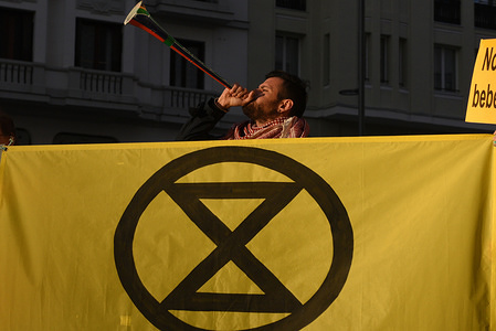 A man is seen making noise during the protest.
Activists from group Extinction Rebellion gathered at Callao square in Madrid to demand to Spanish government policies against the climate change.