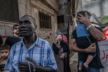 Mourners look at the bodies of four young men killed by the Israeli army in a raid on the town of Tulkarm during the funeral. Four Hamas militiamen were buried in the West Bank city of Tulkarm. The young men, identified as Mohamed Abu Aisheh, 22 years old; Ahmed Abu Qatada, 21 years old; Ibrahim Abu Qatada, 20 years old; and Mahmoud Abu Qatada, 19, were killed by the Israeli army in a raid on the city.
