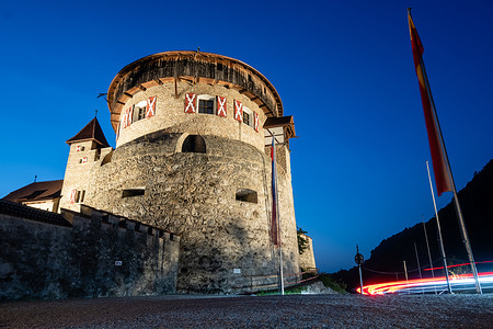 Illuminated Vaduz Castle, in German Schloss Vaduz, official residence of the Prince of Liechtenstein seen during dusk. Vaduz is capital of Principality of Liechtenstein. Liechtenstein is one of the smallest countries in the world, with an area around 160 square kilometers and population around 41,000. Liechtenstein is a monarchy headed by the prince of Liechtenstein Hans-Adam II, while his oldest son Alois, Hereditary Prince of Liechtenstein acts as the regent.